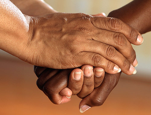 Close-up of two people's embraced hands
