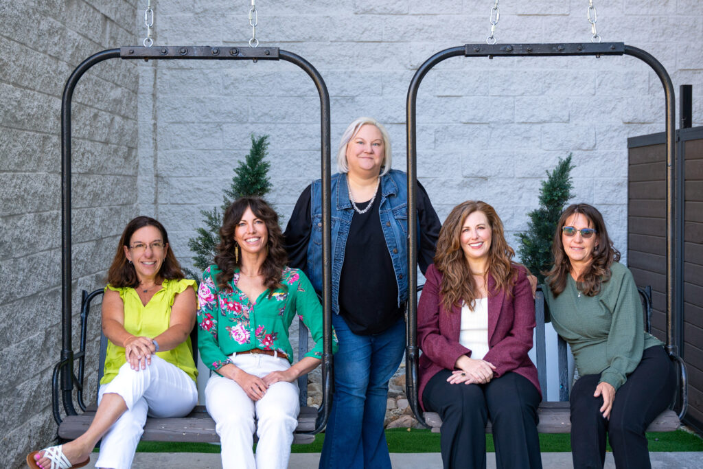 Photo of Vintage team sitting on two swings
