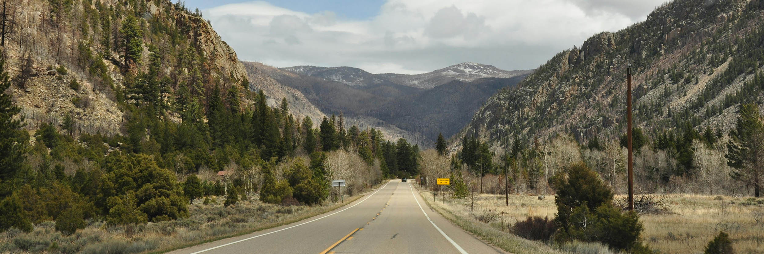 Photo of highway leading towards mountains in the distance